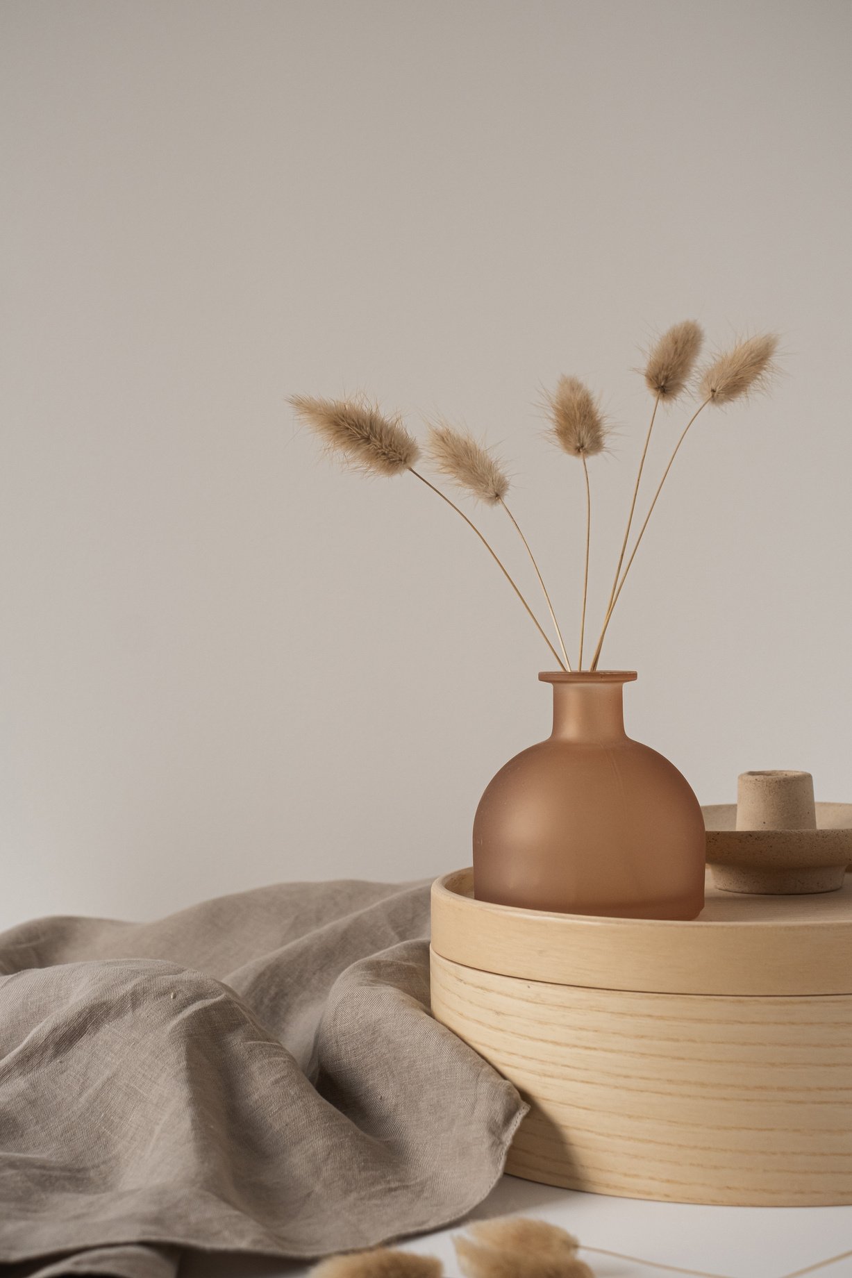 Bunny Tail Grass in a Vase on Wooden Tray with Gray Napkin 